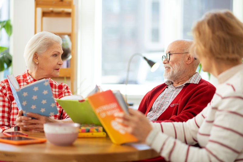 seniors engaging in a conversation at a book club meeting