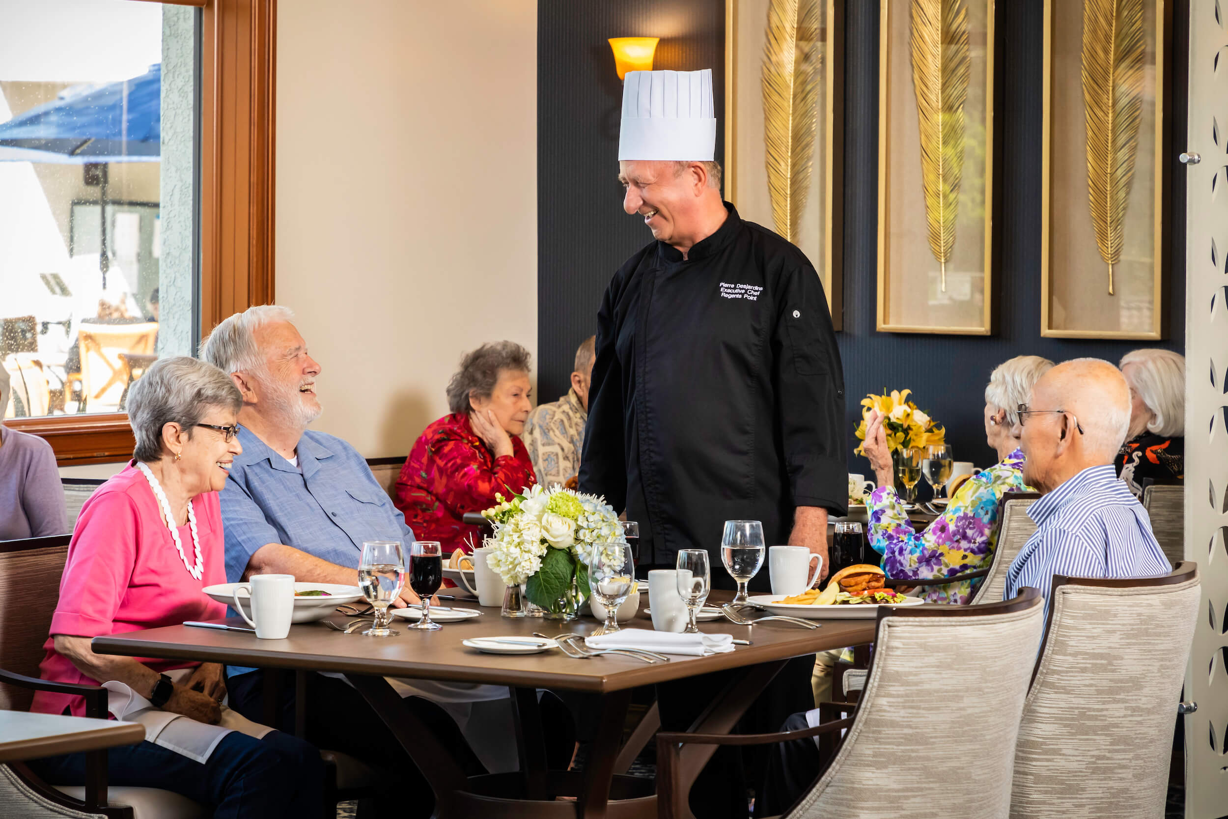 Chef talking to residents at the dinner table