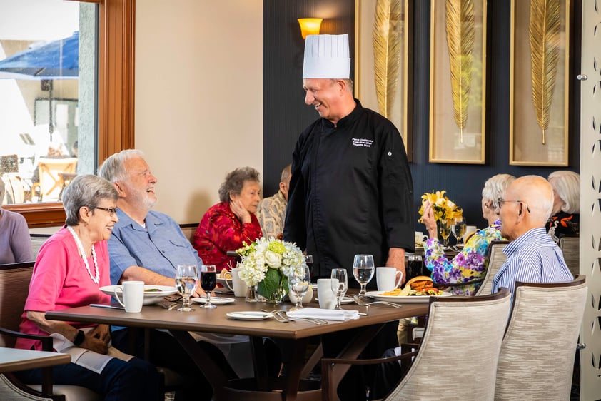 Chef talking to residents at the dinner table