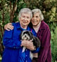Jo Ann and Pat holding their Havanese dog, Darcy