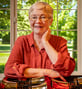 Marcia posing and smiling next to musical instruments