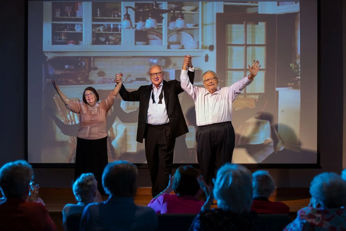 Three residents on stage after a performance