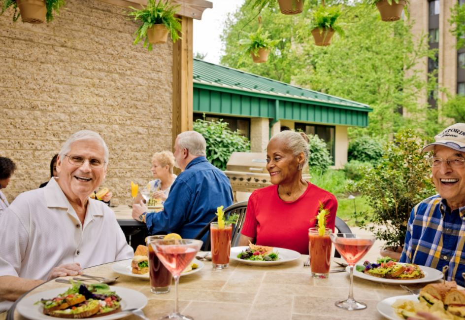 Seniors enjoying a meal on outdoor patio
