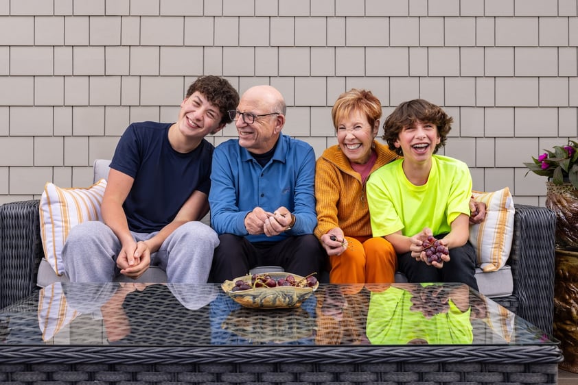 Senior couple sitting outside with their teenage grandsons