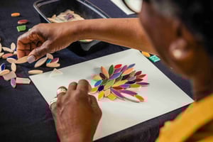 Senior woman creating a mosaic flower