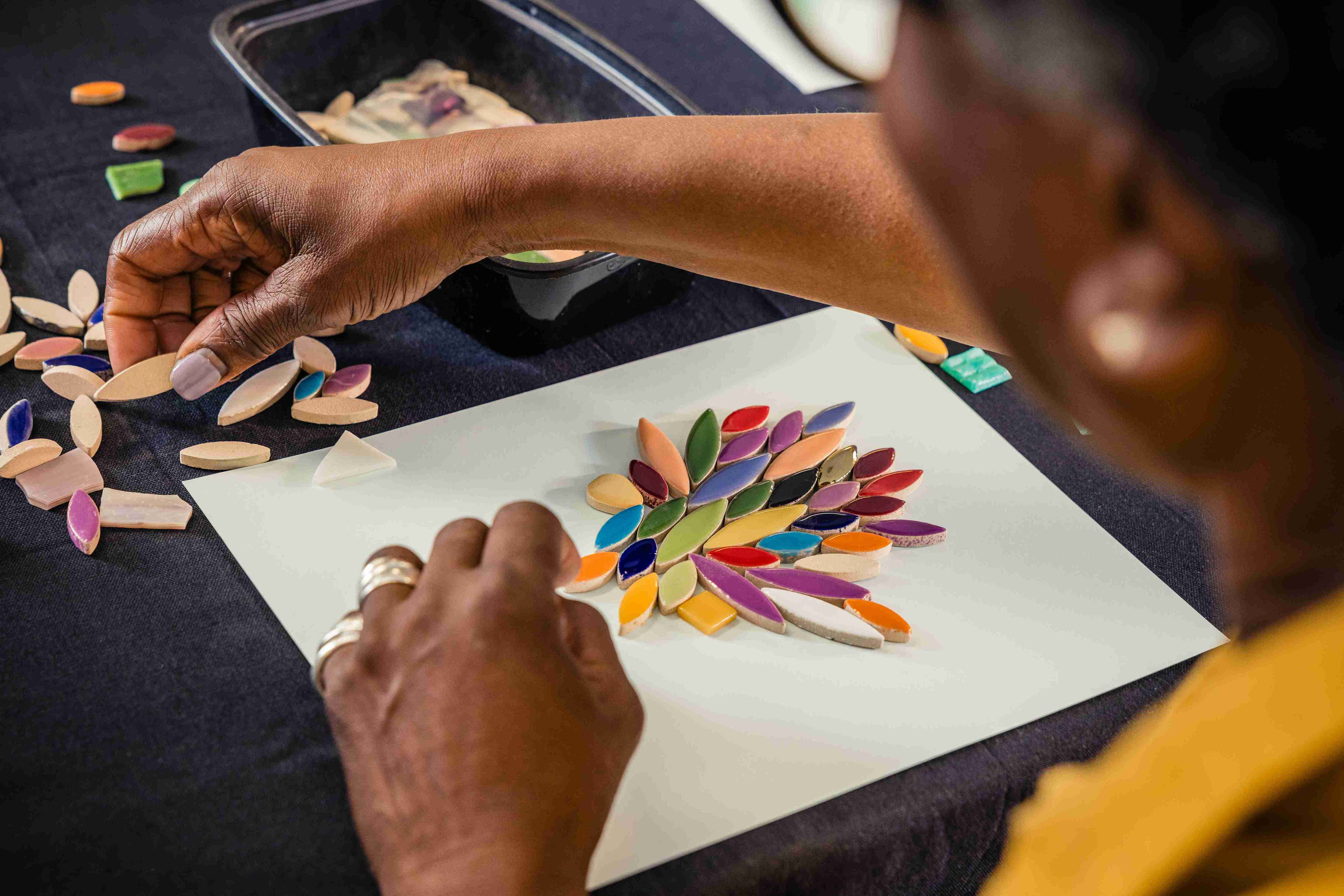 Senior woman creating a mosaic flower