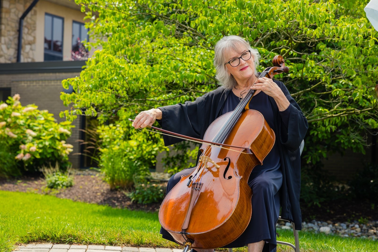 woman playing cello outside