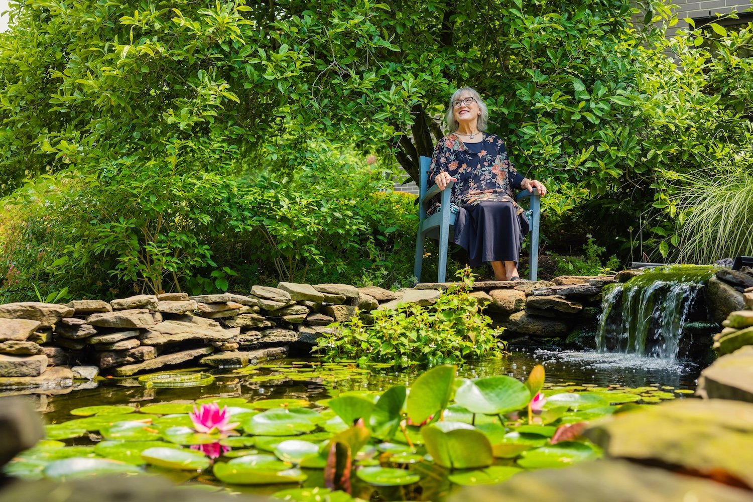 woman sitting by pond