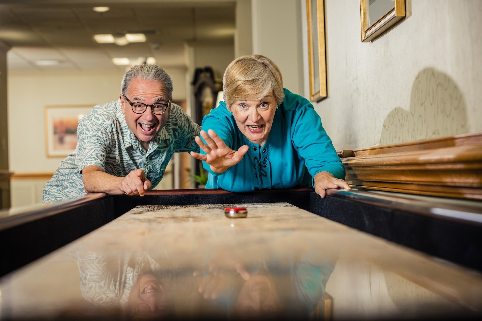 two residents playing shuffleboard