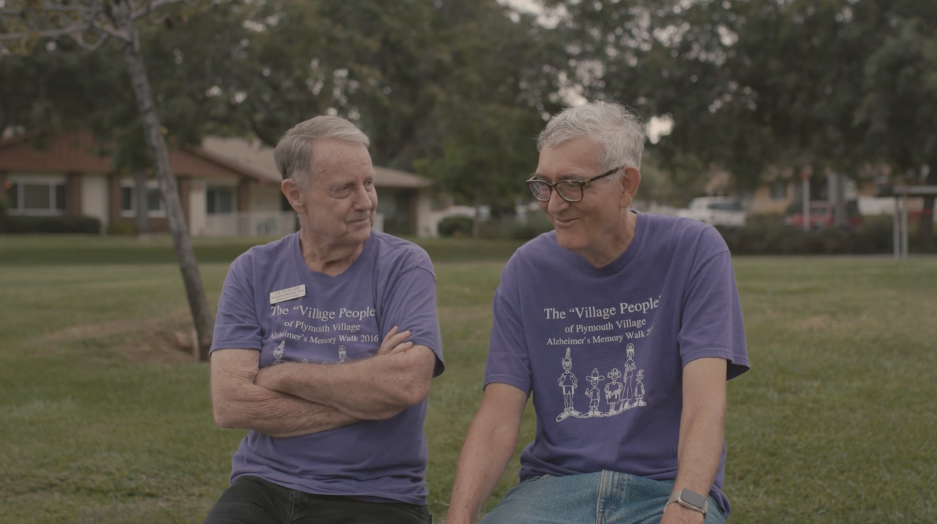 two residents talking outside