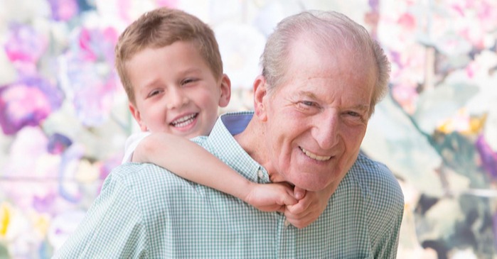 Grandfather carrying his grandson on his back