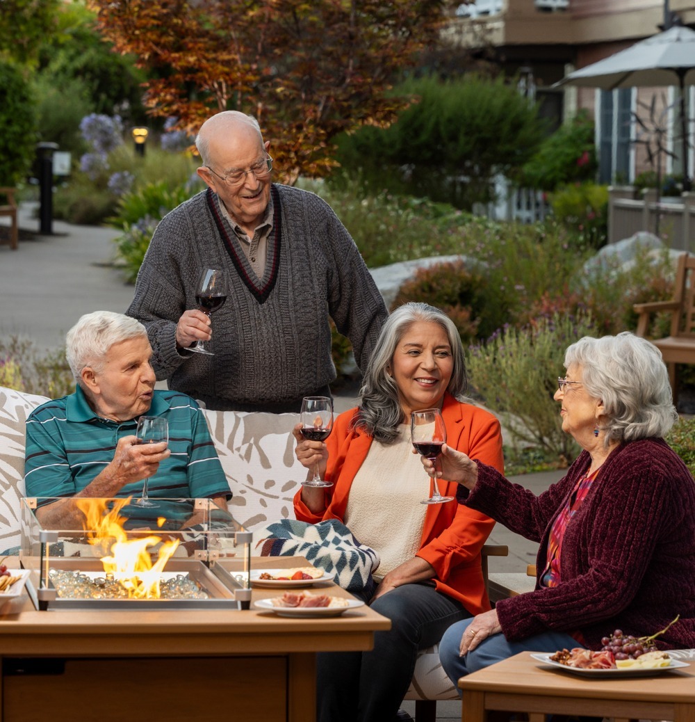 Friends gathering in a patio with a glass of wine
