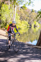 Senior man riding his bike by the water