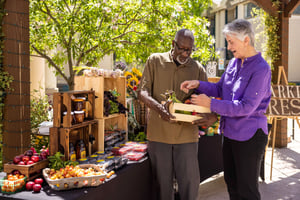 Senior man and senior woman shopping for produce at a farmers market