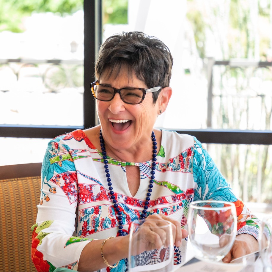 A woman laughing in a restaurant