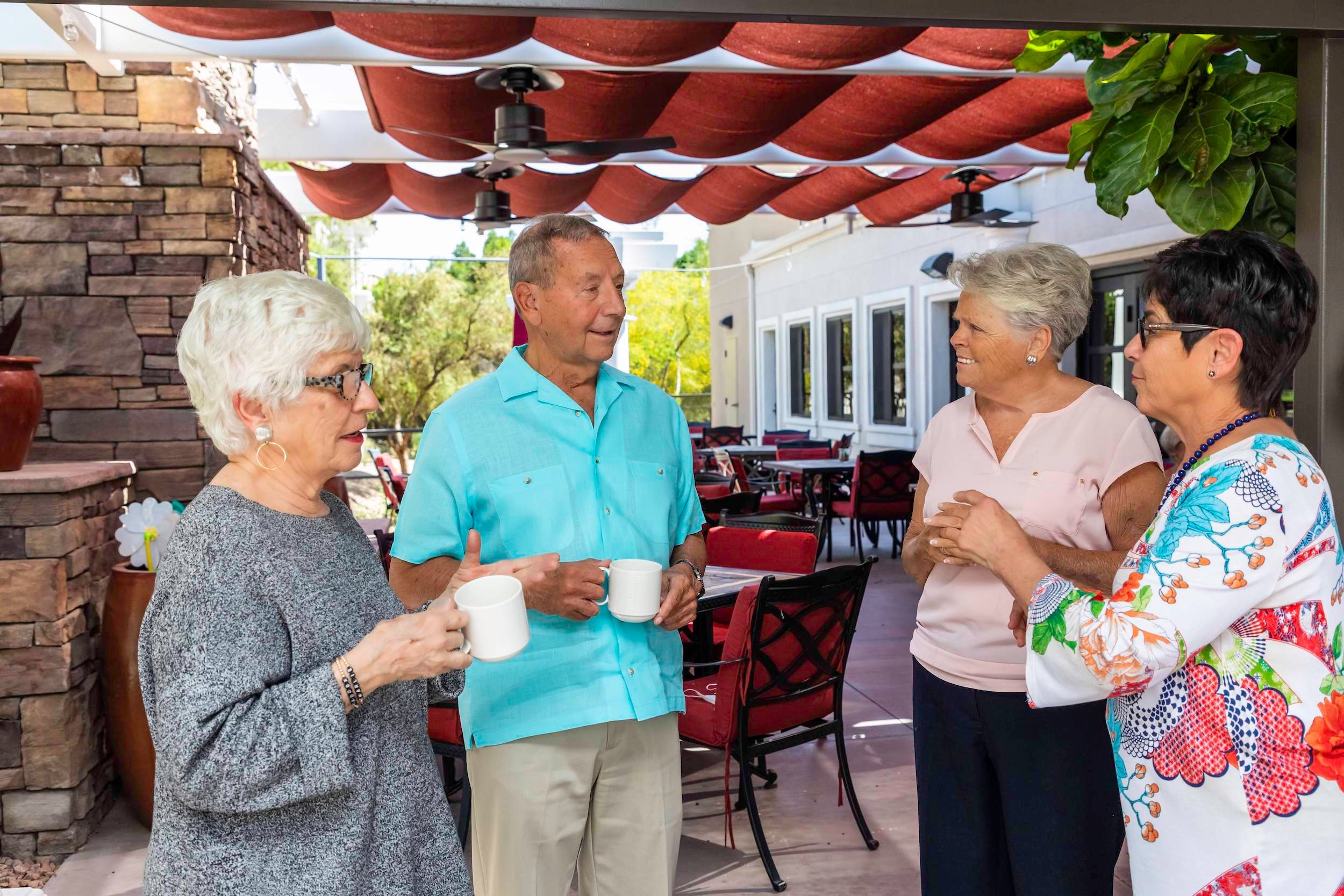 four people drinking coffee