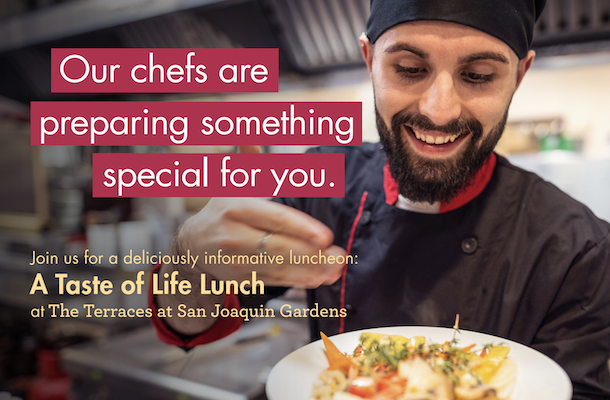 Chef smiling and holding a colorful plated dish. Chef smiling and holding a colorful plated dish.