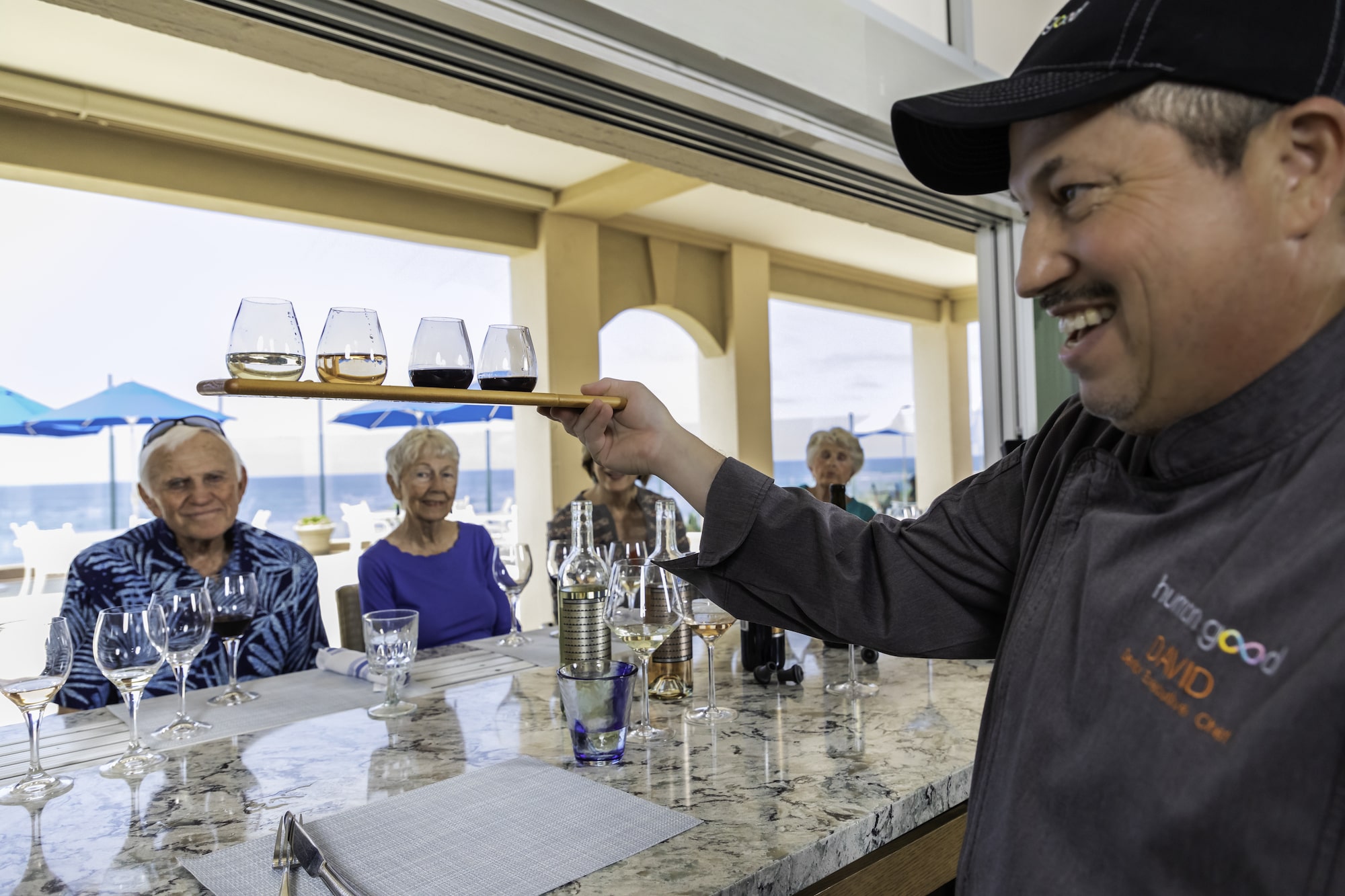 Bartender serving wine to residents