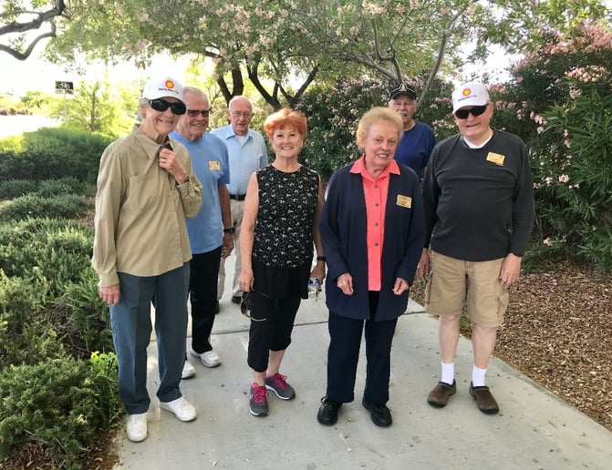 Group of seniors outside on a walking path.