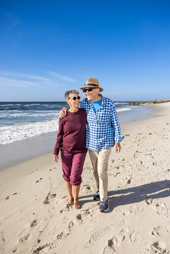 Marilyn and Bob taking a walk along the beach