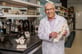 Cliff posing with a model of a spine in a lab