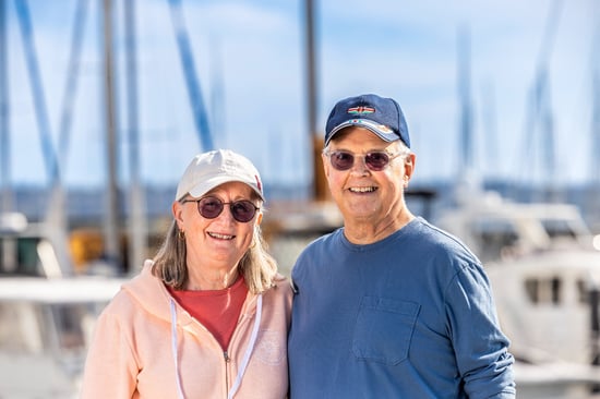 Rick and Susan standing together at a marina.