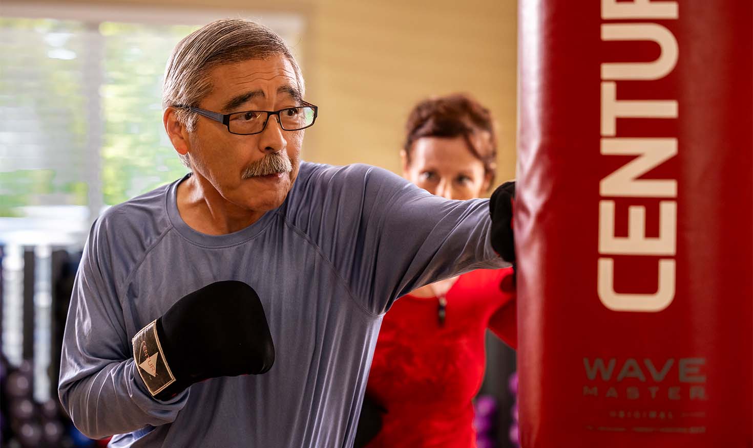 Senior man taking a boxing fitness class