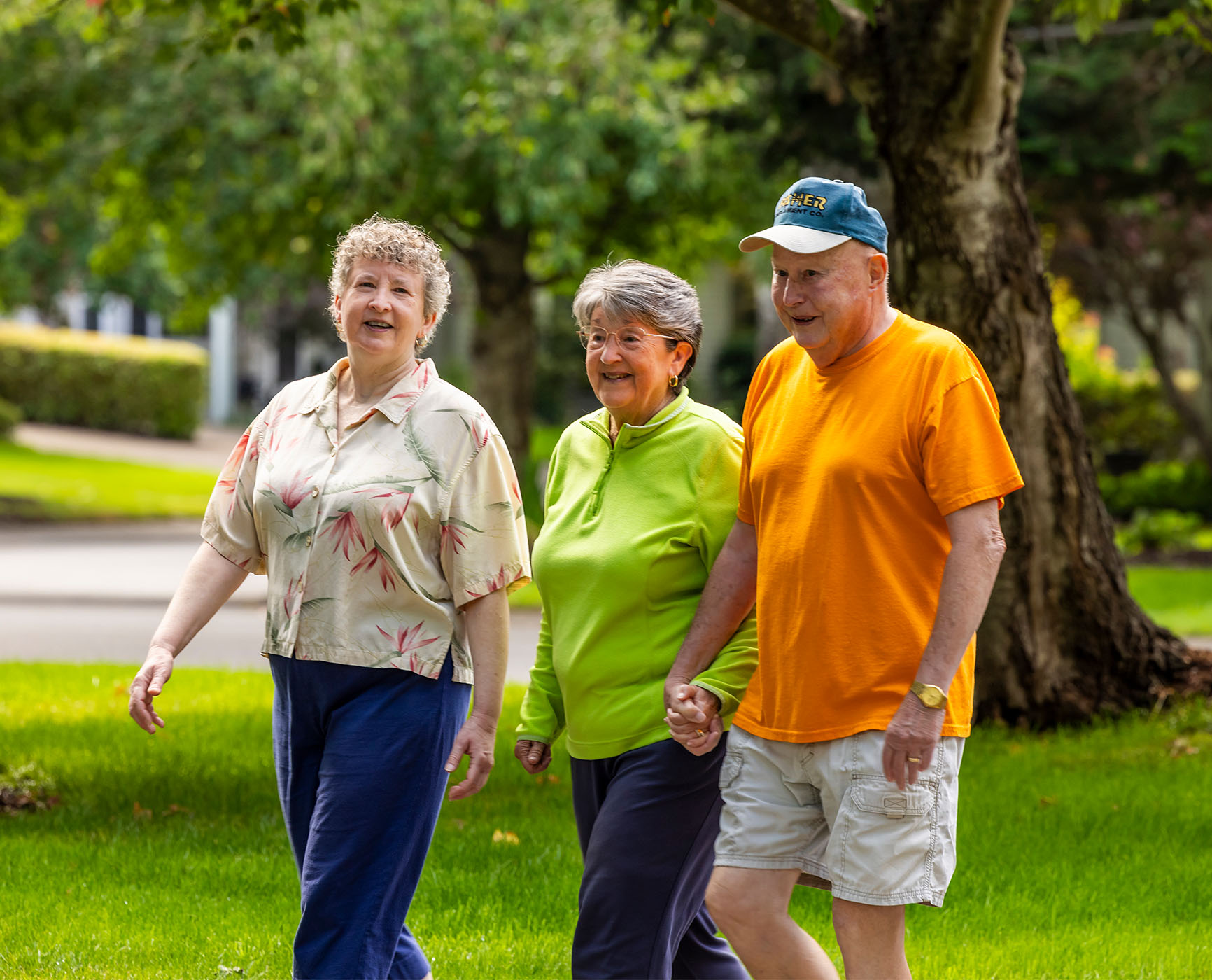 Senior friends walking through lovely neighborhood