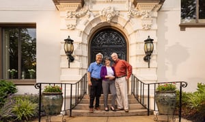 seniors posing on the steps outside mansion doors