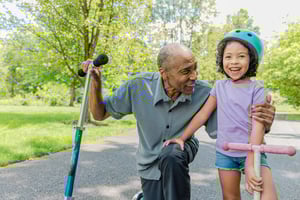 man with his granddaughter on scooter