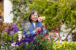 Woman looking at flowers in a garden