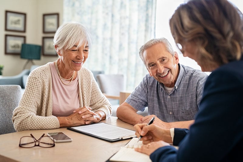Senior couple discussing finances with financial advisor