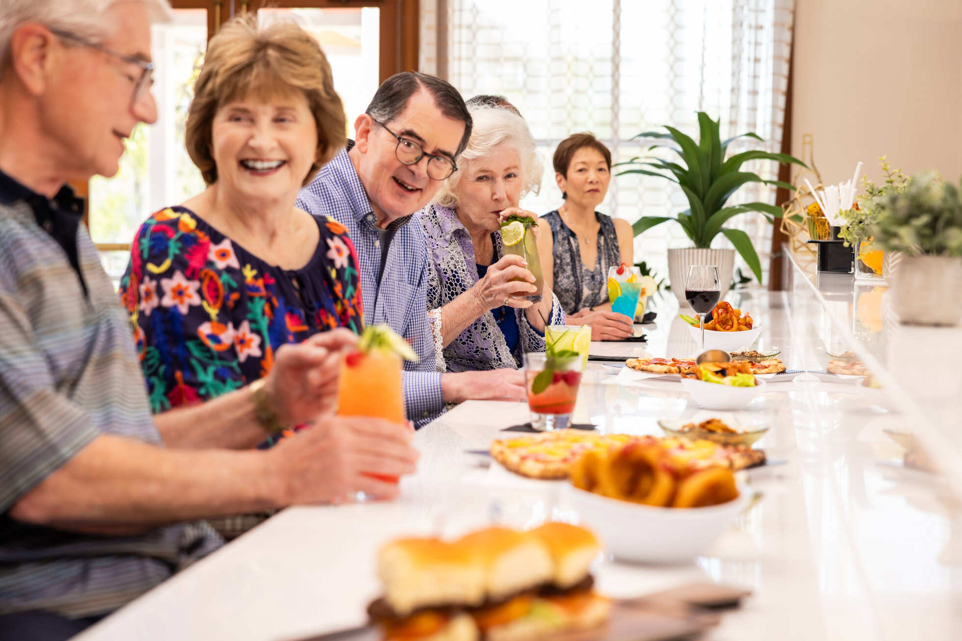 Group of residents eating and drinking at Regents Point