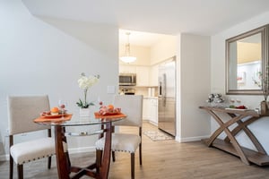 Round glass dining table with two chairs