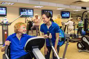 Senior lady working out with trainer