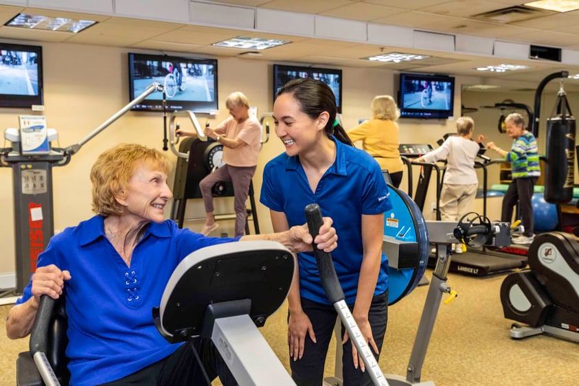 Senior lady working out with trainer