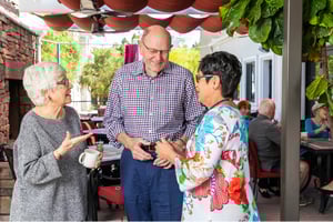 Three seniors chatting on outdoor patio