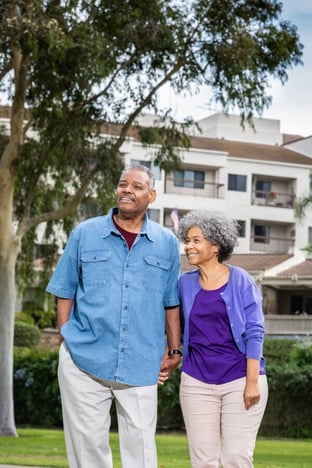 Senior couple holding hands in park