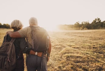 Senior couple walking in an open field