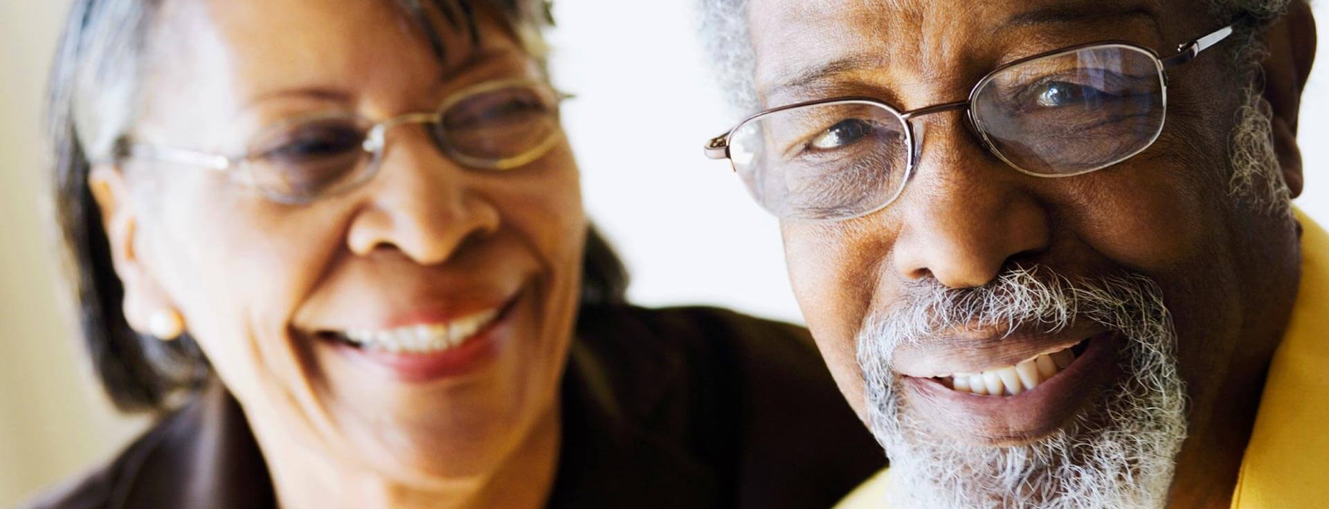 Close-up of senior man and woman, both wearing glasses