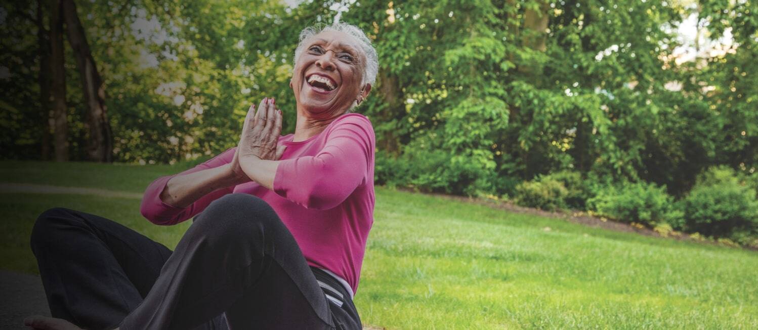 Woman laughing while sitting on the ground