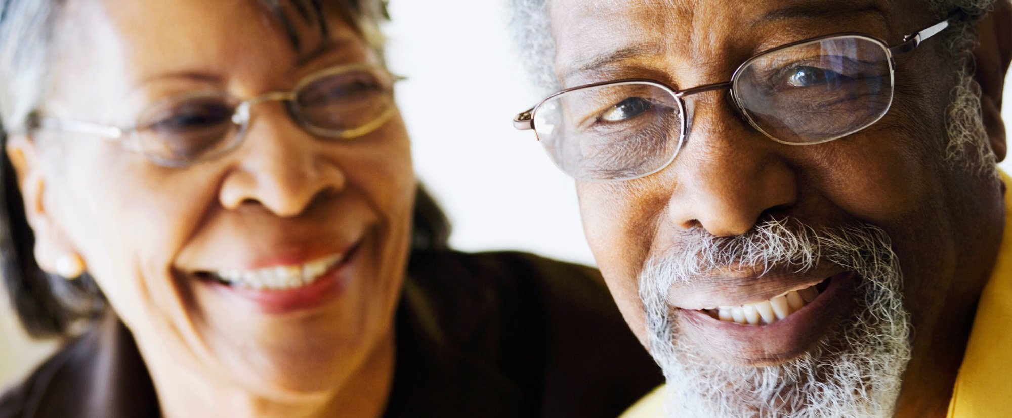Close-up of senior man and woman, both wearing glasses