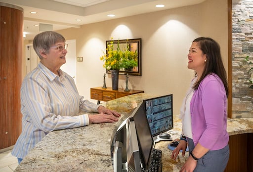 receptionist talking with piedmont garden resident