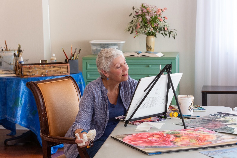 A female resident paints a portrait.