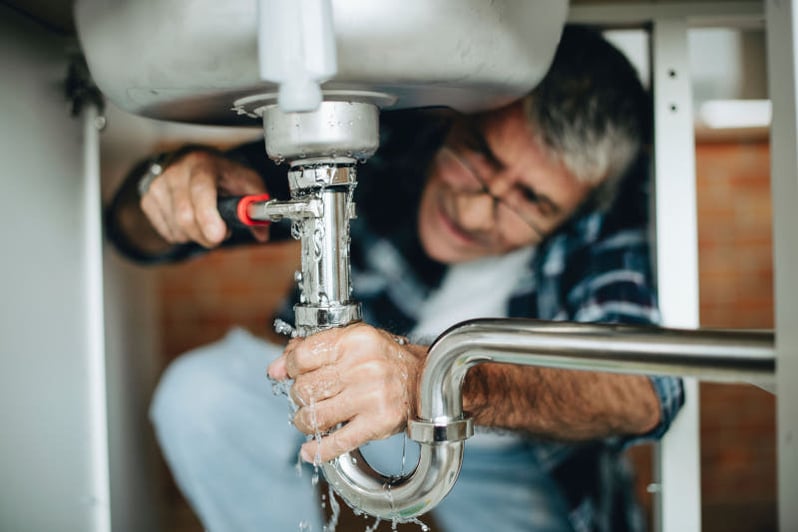 Man fixing a leaky sink