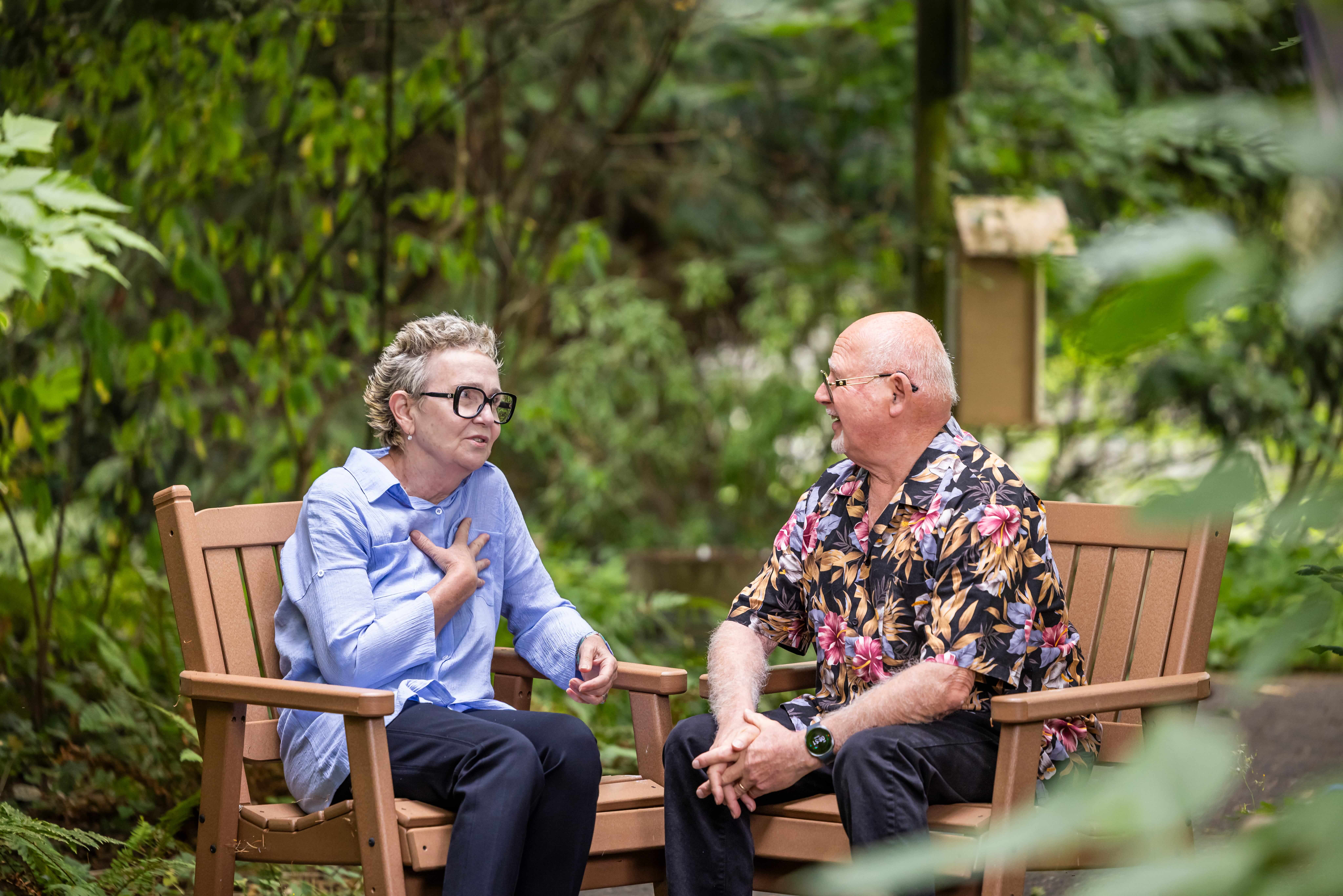 Senior couple having a conversation on outdoor patio