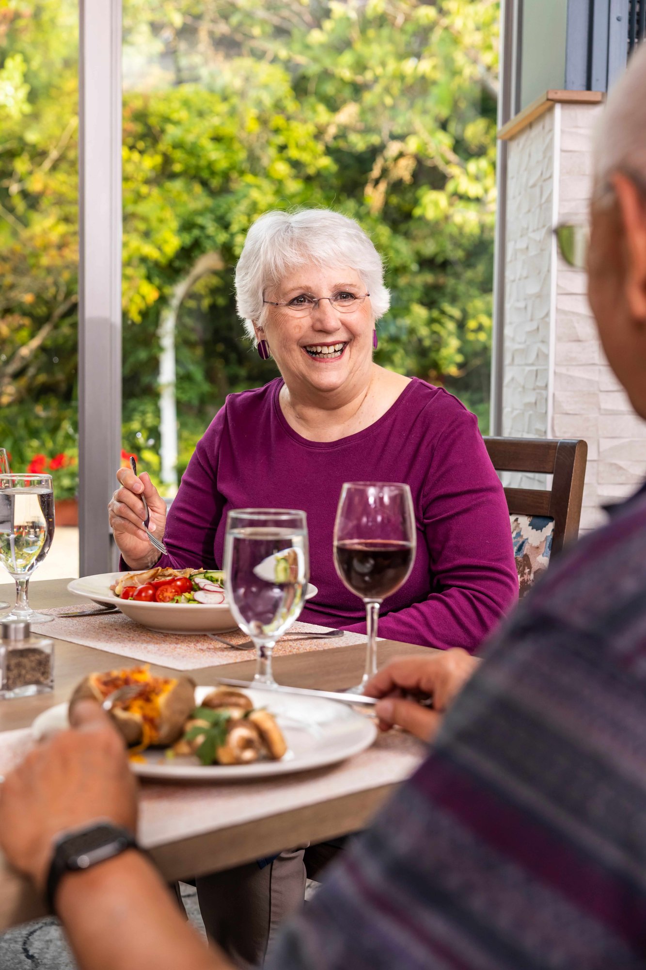 Smiling senior woman enjoying a glass of wine
