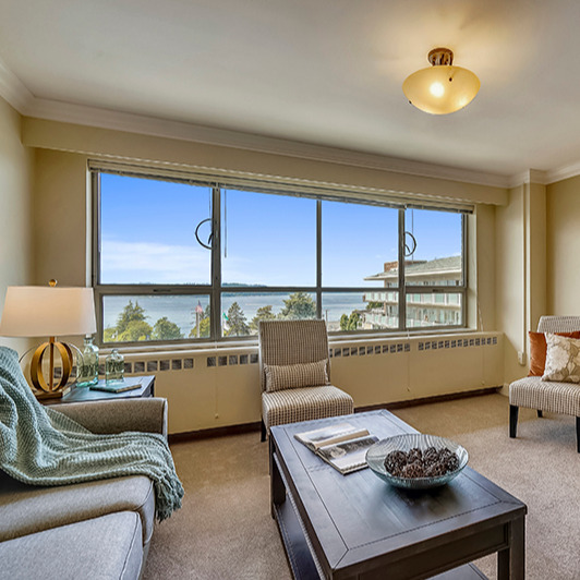 Living room with a coffee table, couch, and chairs