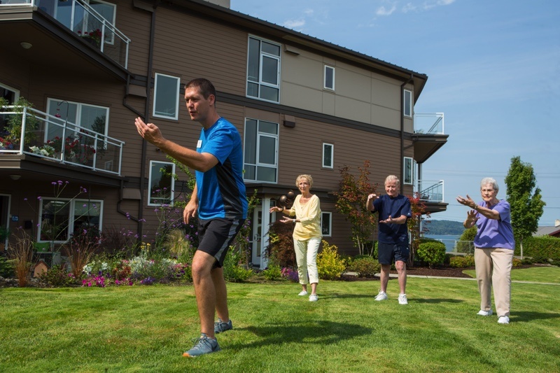 Group fitness class on the lawn at senior living community Judson Park in Des Moines, Washington