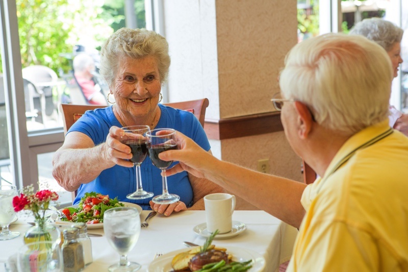 couple cheers with red wine